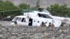 Pakistani soldiers gather beside an army helicopter at a military hospital where victims of a helicopter crash were brought for treatment in Gilgit, on May 8, 2015.