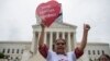 Antonio Surco of Silver Spring, Md. participates in a demonstration outside the Supreme Court in Washington, June 23, 2016. 