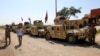 Military vehicles of Iraqi security forces and Shi'ite fighters are seen as they gather at Udhaim dam, north of Baghdad, March 1, 2015. 
