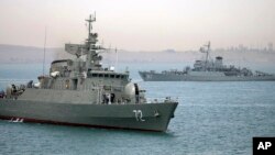 In this picture taken on April 7, 2015 and released by the semi-official Fars News Agency, Iranian warship Alborz (foreground) prepares to leave Iranian waters.