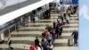 A long line of travelers wait for the TSA security check point at O'Hare International airport, Monday, May 16, 2016, in Chicago. 