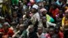 FILE - Refugees who fled Burundi's violence and political tensions wait to board a U.N. ship, at Kagunga on Lake Tanganyika, Tanzania, to be taken to the port city of Kigoma, May 23, 2015.