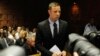 Oscar Pistorius stands in the dock during a break in court proceedings at the Pretoria Magistrates court, February 20, 2013. 