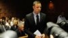 Oscar Pistorius stands in the dock during a break in court proceedings at the Pretoria Magistrates court, February 20, 2013.