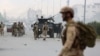 Afghan security forces gather at the site of a complex attack by Taliban fighters in front of the Parliament, in Kabul, Afghanistan, June 22, 2015. 