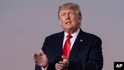 FILE — Former President Donald Trump prepares to take the stage during his Save America rally in Perry, Ga., Sept. 25, 2021.