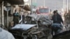 Afghan security personnel gather at the site of a suicide attack in Kabul, Afghanistan, April, 10, 2015. 