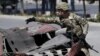 A U.S. soldier inspects the site of a suicide bomb attack in Kabul, Afghanistan, June 30, 2015.