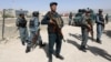 Afghan security forces inspect the site of a suicide attack after clashes with Taliban fighters at the gate of an intelligence facility in Kabul, Afghanistan, July 7, 2015.