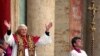 Pope Benedict the 16th waves to the crowd from the central balcony of St. Peter's Basilica after being newly elected, the Vatican, April 19, 2005.