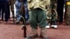 FILE - A former child soldier poses with his gun. According to UNICEF, an armed group fighting Boko Haram in Nigeria has released hundreds of child soldiers that had been recruited into its ranks. 