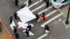 New York Police Department officers prepare to cover a body after a shooting in midtown Manhattan in New York, U.S., May 18, 2016.