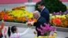 Afghanistan's President Ashraf Ghani Ahmadzai (L) waves to students as he and China's President Xi Jinping attend a welcoming ceremony outside the Great Hall of the People, in Beijing, Oct. 28, 2014.