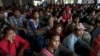 Cambodian workers wait for their documents to be processed at the Aranyaprathet police station as they prepare to move back to Cambodia in Sa Kaew, Thailand, June 15, 2014.