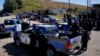Police officers are seen near Chiquix village, where 13 people were killed, in Nahuala, Guatemala, on December 19, 2021. 
