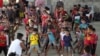 FILE - Children who traveled with their families from Venezuela play at the shelter in Arauquita, Colombia, March 25, 2021, on the border with Venezuela.