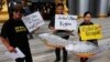 Villagers hold fish-shaped placards at Thailand's Administrative Court, Bangkok, June 24, 2014.