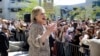FILE - Democratic presidential candidate Hillary Clinton speaks to people in the overflow area during a campaign event at Los Angeles Southwest College in Los Angeles, April 16, 2016. Despite a formidable challenge from Senator Bernie Sanders, Clinton is likely to clinch the nomination June 7.