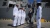 Ukrainian Prime Minister Arseniy Yatsenyuk, center, leaves the USS Donald Cook, the Navy's newest missile cruiser, and passes by the guard of honor in Odessa, Ukraine, Sept. 1, 2015.