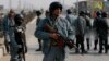 FILE - Afghan policemen keep watch at the site of clashes with protesters in Kabul, Jan. 31, 2015. 