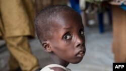 A boy suffering from severe acute malnutrition sits at one of the UNICEF nutrition clinics, in the Muna informal settlement, which houses nearly 16,000 IDPs (internally displaced people) in the outskirts of Maiduguri capital of Borno State, northeastern Nigeria.