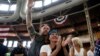 People applaud a speaker as they wait for Republican nominee Donald Trump to speak at "Joni's Roast and Ride" in Des Moines, Iowa, U.S., Aug. 27, 2016. 
