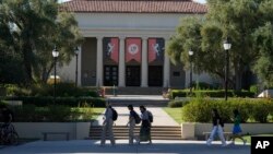 FILE - Students walk past the Thorne Hall at Occidental College campus in Los Angeles, July 27, 2023.