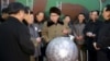 김정은 북한 국방위원회 제1위원장이 핵무기 연구 부문 과학자, 기술자들을 만나 핵무기 병기화 사업을 지도하는 모습을 지난 9일 조선중앙통신이 보도했다. 사진 아래쪽에 핵탄두 기폭장치 추정 물체가 보인다. (자료사진)
