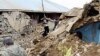 People walk around a destroyed house in Karakocan province of southeastern city Elazig, Turkey, 08 Mar 2010
