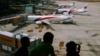 FILE - Children look at Malaysia Airlines Boeing 737-800 aircrafts parked at Kuala Lumpur International Airport, June 14, 2014.