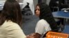 FILE - Chanel Ferran Gutierrez, a 10th grade student at Newcomer Academy, prepares to be vaccinated during a pop-up immunization clinic in the school's library in Louisville, Ky., on Aug. 8, 2024. 