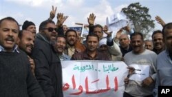 Suez Canal Company workers protest as they began an open-ended strike in front of the company's headquarters in Ismailia City, Egypt,Wednesday, Feb. 9, 2011. The canal stayed open as everal hundred workers demonstrated, demanding the resignation of their 