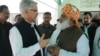 Pakistani Defense Minister Khawaja Muhammad Asif, left, confers with Jamat Ulema-e-Islam religious party leader Maulana Fazalur Rehman outside Parliament in Islamabad, April 10, 2015. Legislators decided not to join the Saudi-led coalition.