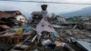 A teddy bear hangs next to earthquake and tsunami damaged property along the waterfront in Palu, Central Sulawesi, Indonesia, Oct. 10, 2018.