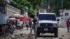 Police remove a roadblock set by protesters in Port-au-Prince, Haiti, Oct. 18, 2021. 