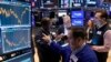Specialist Genaro Saporito, foreground, works with traders at his post on the floor of the New York Stock Exchange, Sept. 18, 2024. 
