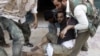 A Free Syrian Army fighter is wounded during a fight with forces loyal to President Bashar Al-Assad in downtown Aleppo, August 1, 2012. 