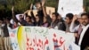 Pakistani students shout slogans against the Islamic State group holding a banner that reads "down with Islamic State rally," in Islamabad, Nov 20, 2014.