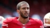 FILE - San Francisco 49ers quarterback Colin Kaepernick stands on the field before their NFL pre-season football game against the Denver Broncos in San Francisco, California.